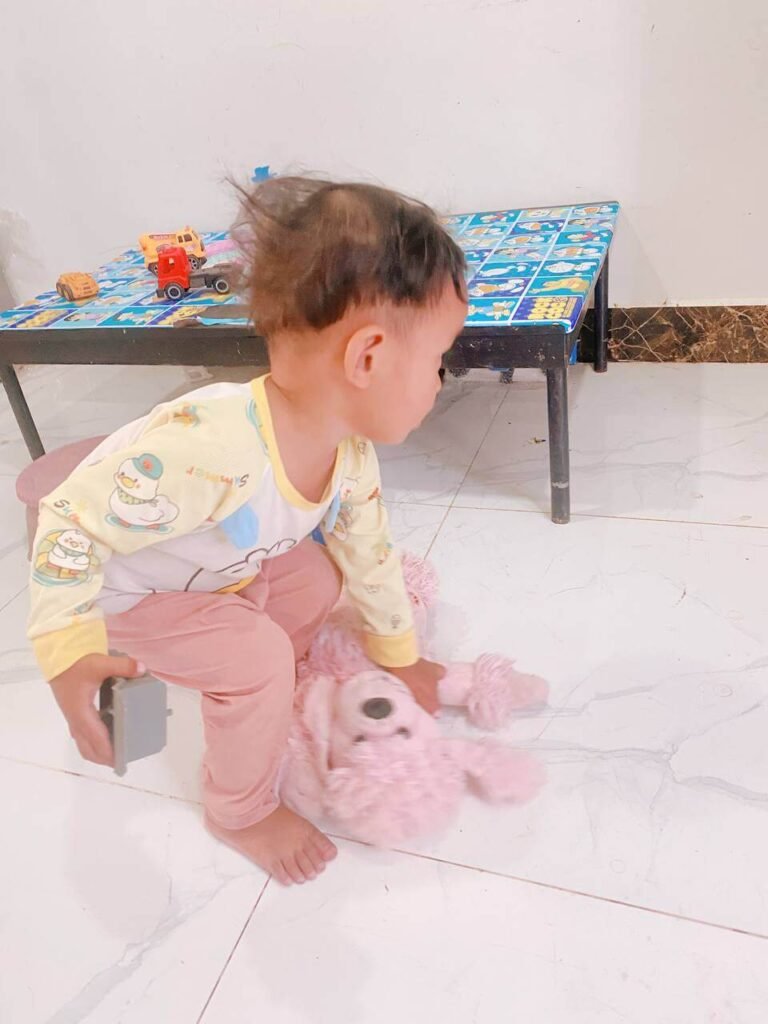 Getting their attention first turns picking up scattered toys into a shared discovery, rather than a forced chore.