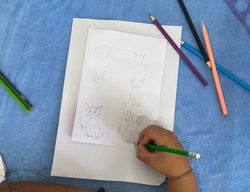 Step-by-step progression of a child drawing an easy sitting cat, starting from a simple circle and finishing the outline with a green pencil.