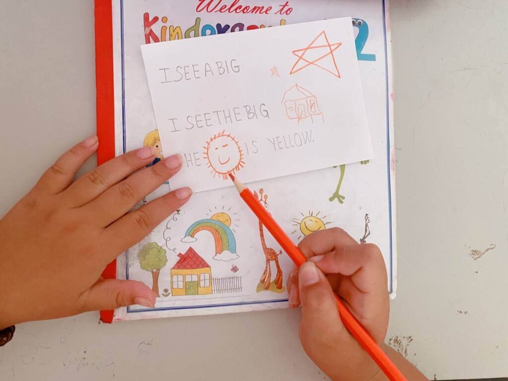 A homemade read, trace, and draw worksheet where a child drew a smiling sun to show they understood the sight word sentence.